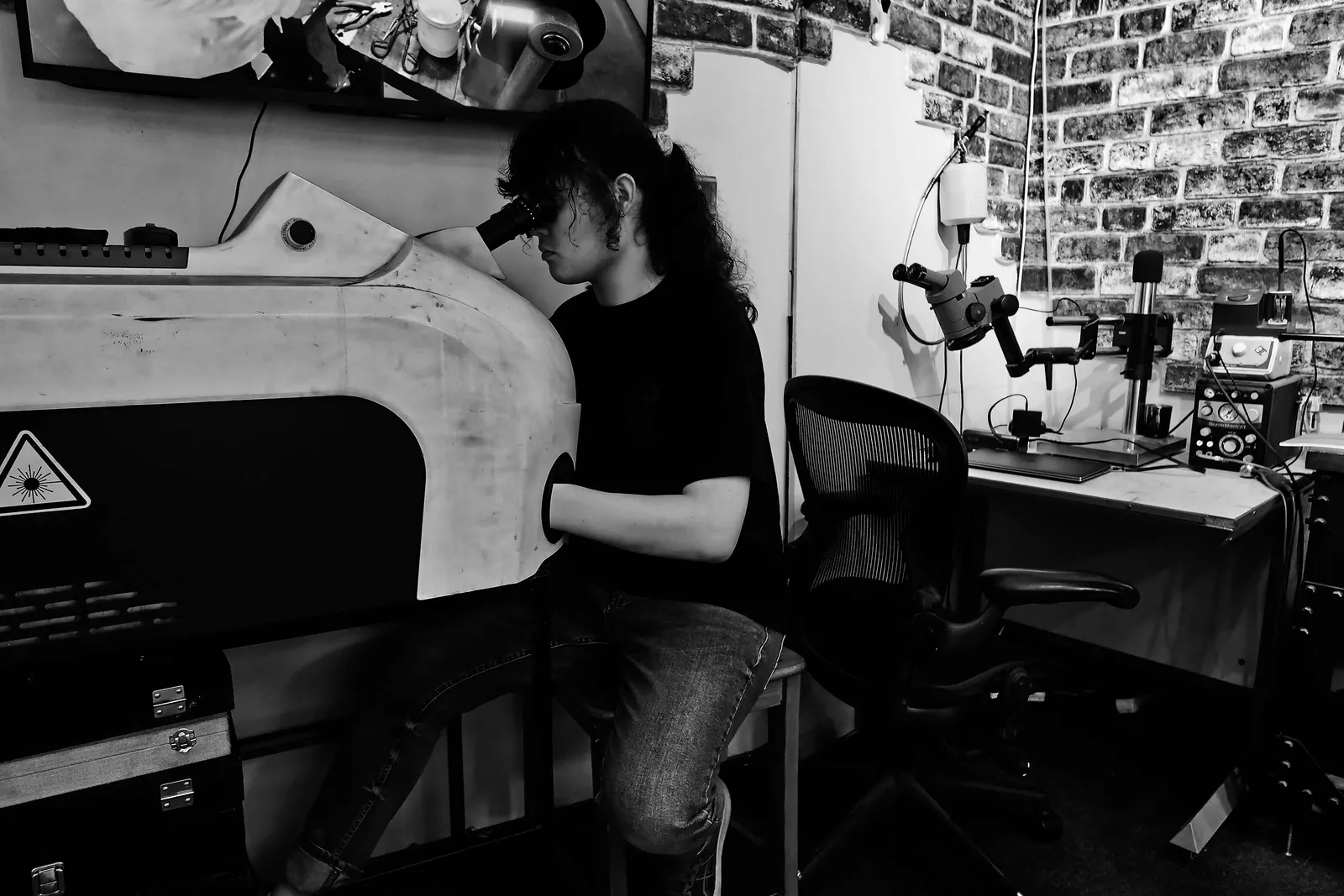 James inspecting jewellery at a microscope